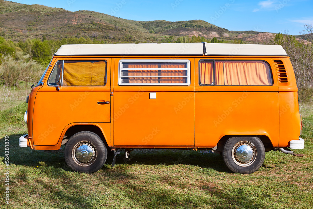 Vintage camper van under a blue sky. Recreational vehicle. Summertime