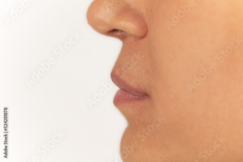 Close-up of female lips on white background before lip augmentation.
