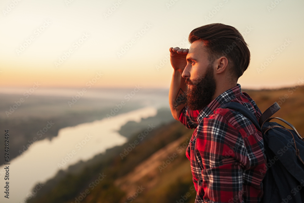 Fotografie Bearded tourist looking at distance