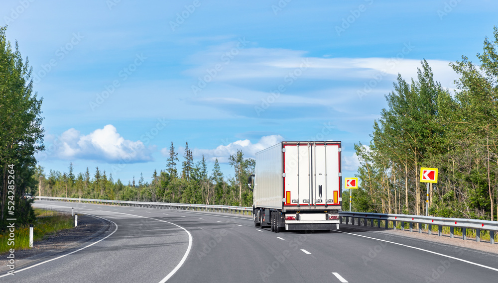 Truck transportation on island Finland road at sunny day. Concept banner logistic cargo speed