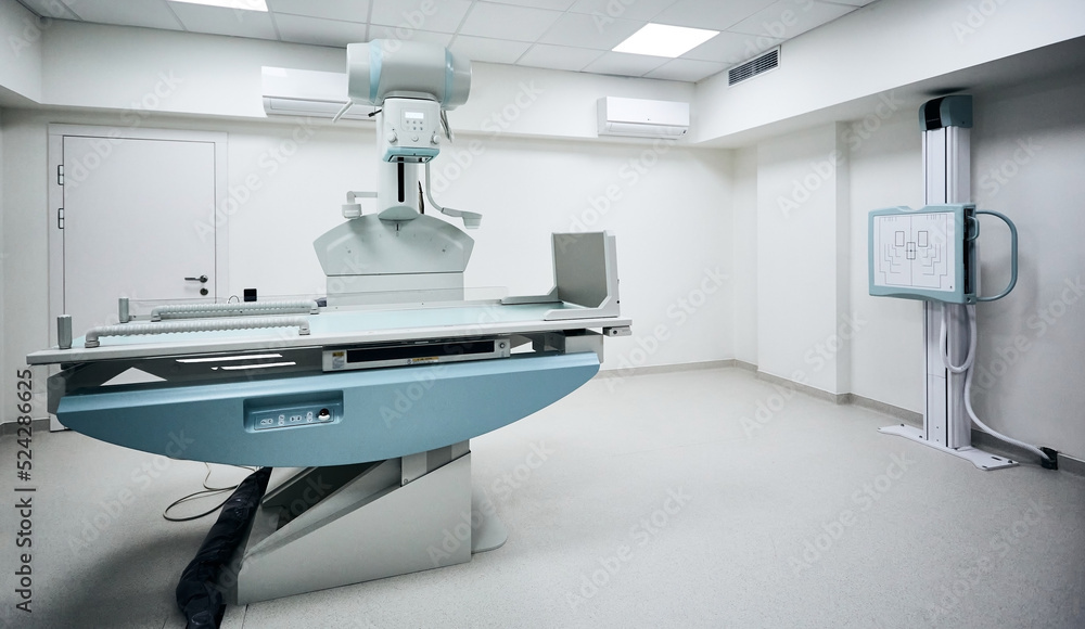 Xray room with modern Xray machine in hospital. Radiographic imaging