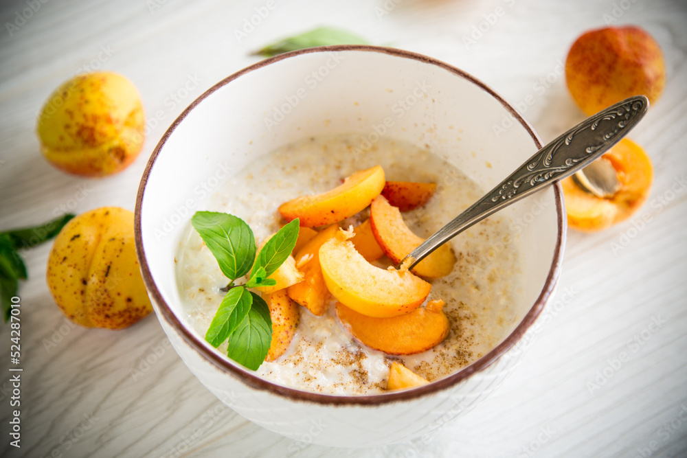 Healthy breakfast of apricot oatmeal with fresh fruit Healthy breakfast of apricot oatmeal with fresh fruit