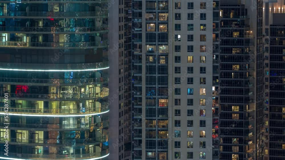 Big glowing windows in modern office and residential buildings timelapse at night, in rows of windows light shines. Tall skyscrapers Big glowing windows in modern office and residential buildings timelapse at night, in rows of windows light shines. Tall skyscrapers