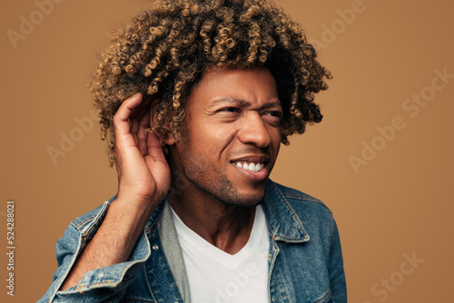 Deaf man trying to hear distinctly photo