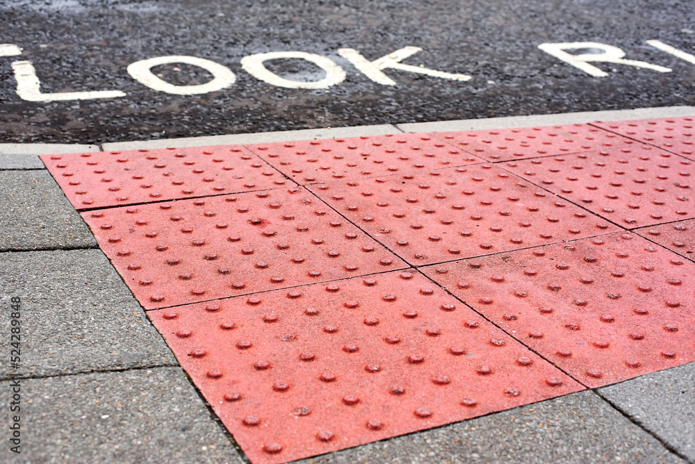 Tactile tiles for the blind. Panels for the blind laid on asphalt