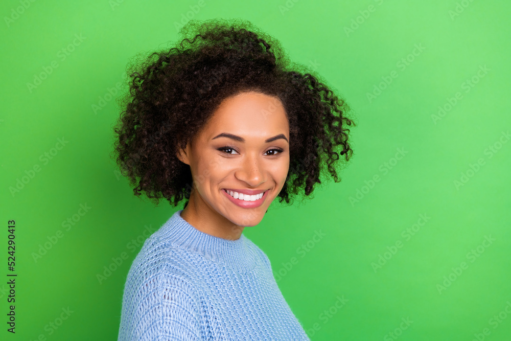 Portrait of young beautiful cute nice girl with perming coiffure dressed blue pullover smile on camera isolated on green color background Portrait of young beautiful cute nice girl with perming coiffure dressed blue pullover smile on camera isolated on green color background