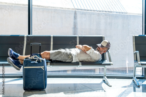 man in the airport sleeps on the armchairs