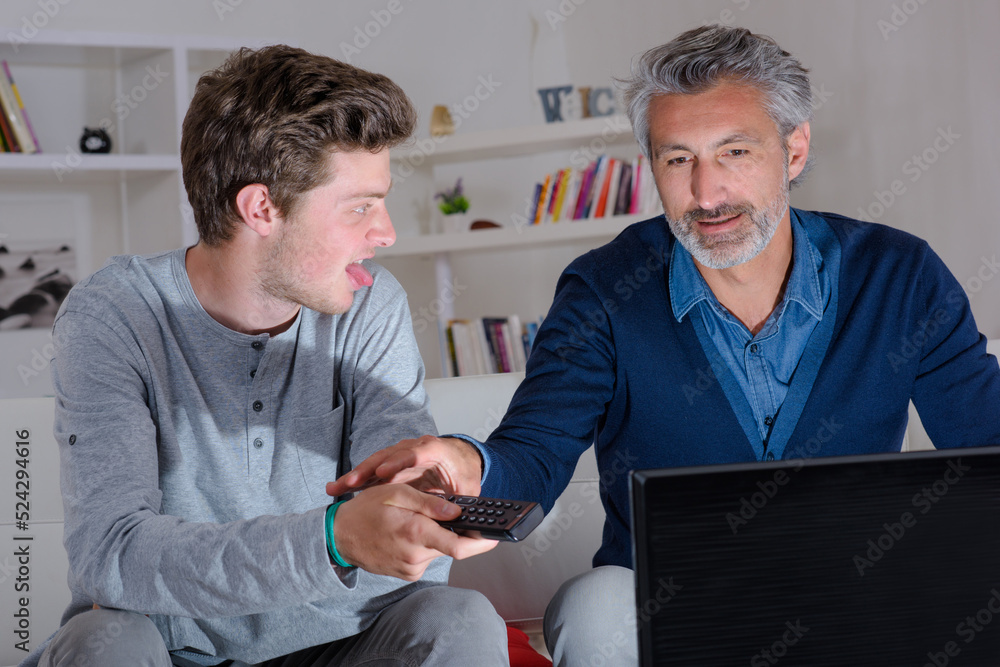 two men are watching television two men are watching television