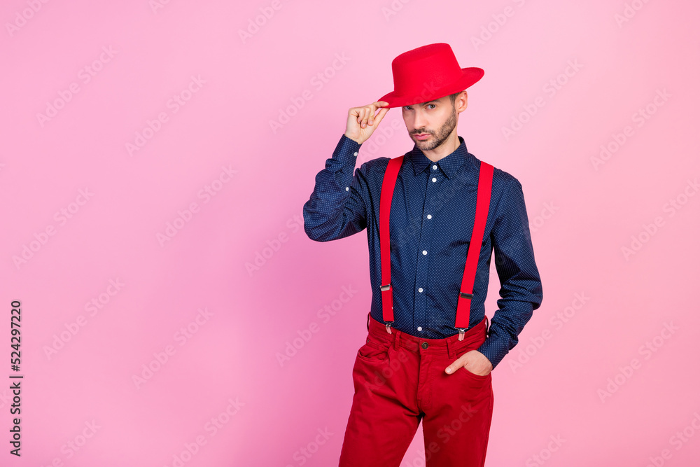 Portrait of serious person hand touch headwear posing empty space isolated on pink color background Portrait of serious person hand touch headwear posing empty space isolated on pink color background