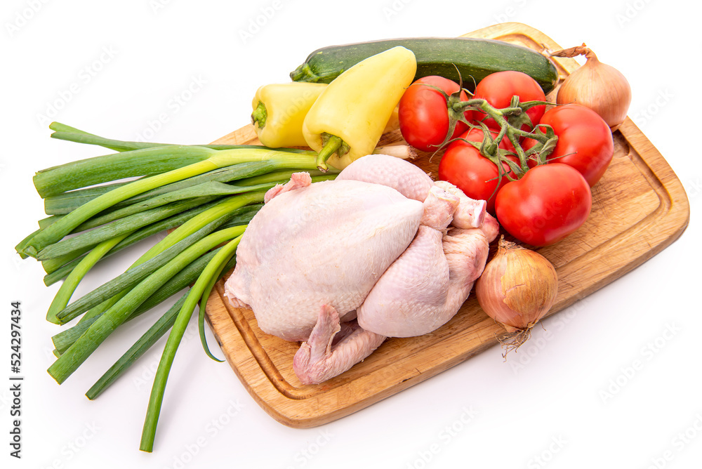 Raw chicken and vegetables on a cutting board Raw chicken and vegetables on a cutting board