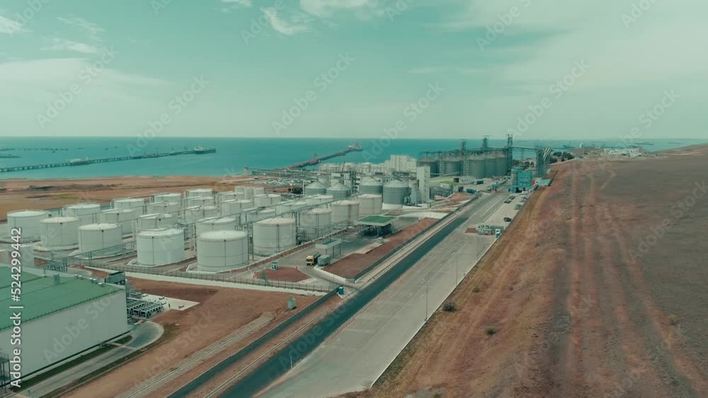 Port and industrial buildings. Top view. The sea is visible on the horizon. 4K Port and industrial buildings. Top view. The sea is visible on the horizon. 4K
