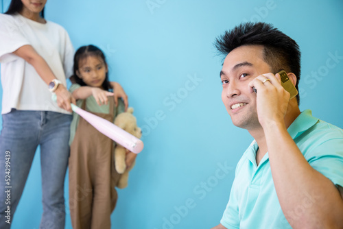 Family Conflicts. Young Asian girl standing with mother have angry mood fended father after quarrel at home. Father secretly has an affair and cheats on his wife. Soft focus