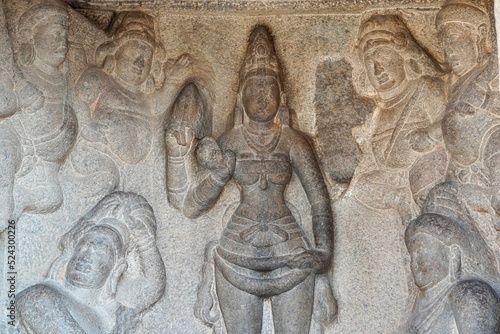 Bas relief rock cut sculptures of gods, people and animals are carved prominently in the monolithic cave temples at Mahabalipuram, Tamil nadu, India photo