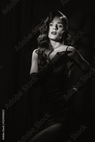 Portrait of woman in classic vintage noir image. Photo of girl in retro style of black and white Hollywood movies. © alexkoral