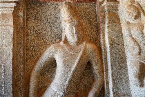 Bas relief rock cut sculptures of gods, people and animals are carved prominently in the monolithic cave temples at Mahabalipuram, Tamil nadu, India photo