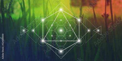 Merkaba sacred geometry spiritual new age futuristic illustration with interlocking circles, triangles and glowing particles in front of blurry natural photographic background