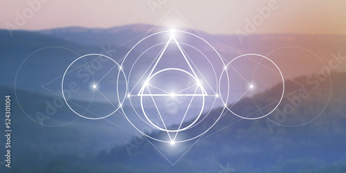 Sacred geometry spiritual new age futuristic illustration with interlocking circles, triangles and glowing particles in front of blurry natural photographic background