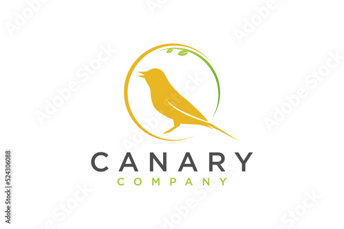 Yellow Canary bird logo design perched on a tree branch organic nature earth animal