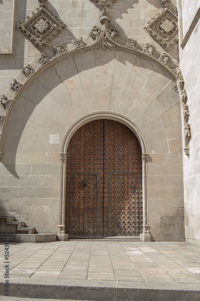 Gothic entrance door of the Casa de la Ciudad de Barcelona building in Barcelona. Spain