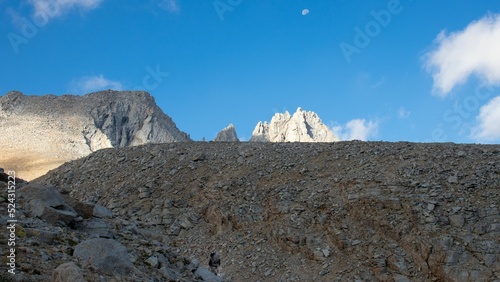 Horizontal shot of a Jon Muir Trail's rocky mountains under a clear, blue sky in California photo