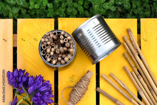 DIY insect hotel build with tin can and bamboo. Solitary bee shelter to hang in the garden. Build an insect nest box with recovery object