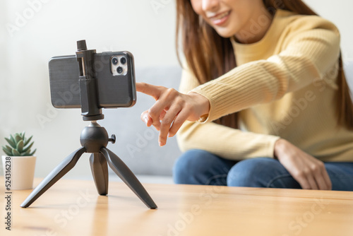 Vlogger influencer, asian young woman blogger, content maker hand in setting camera, prepare recording interview on smartphone, talk on video shoot social media, live broadcast with technology at home photo