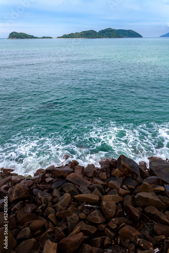 ocean waves beat against the rocks. We can see the foam on the sea. The rushed ocean, and ravishing warm water in Brazil