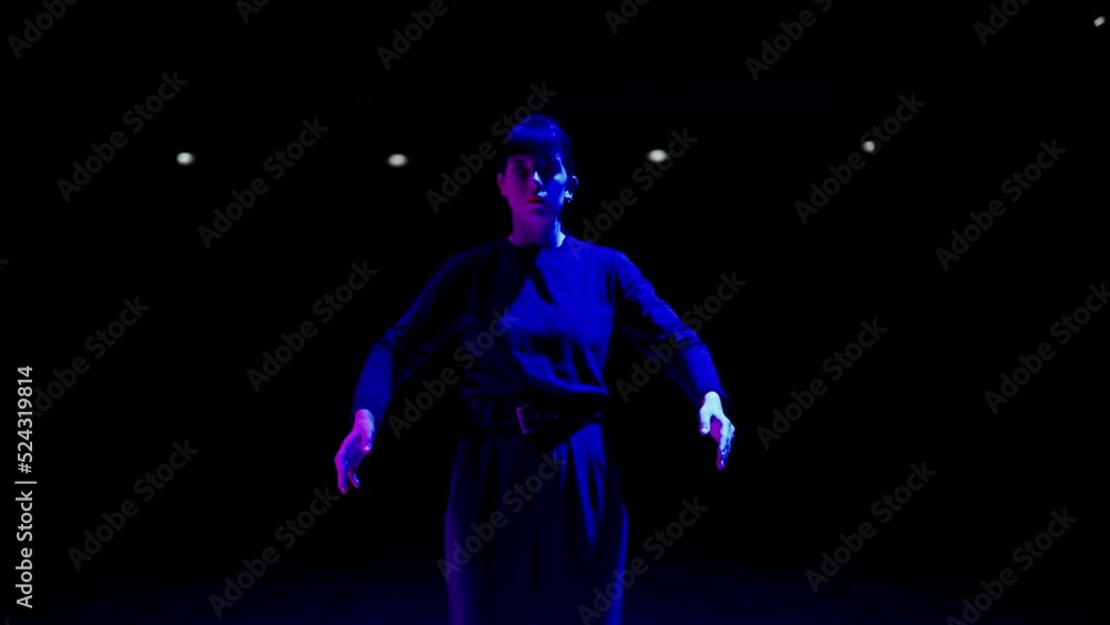 enigmatic dance show on theatre scene, portrait of dancing woman in artistic blue light enigmatic dance show on theatre scene, portrait of dancing woman in artistic blue light