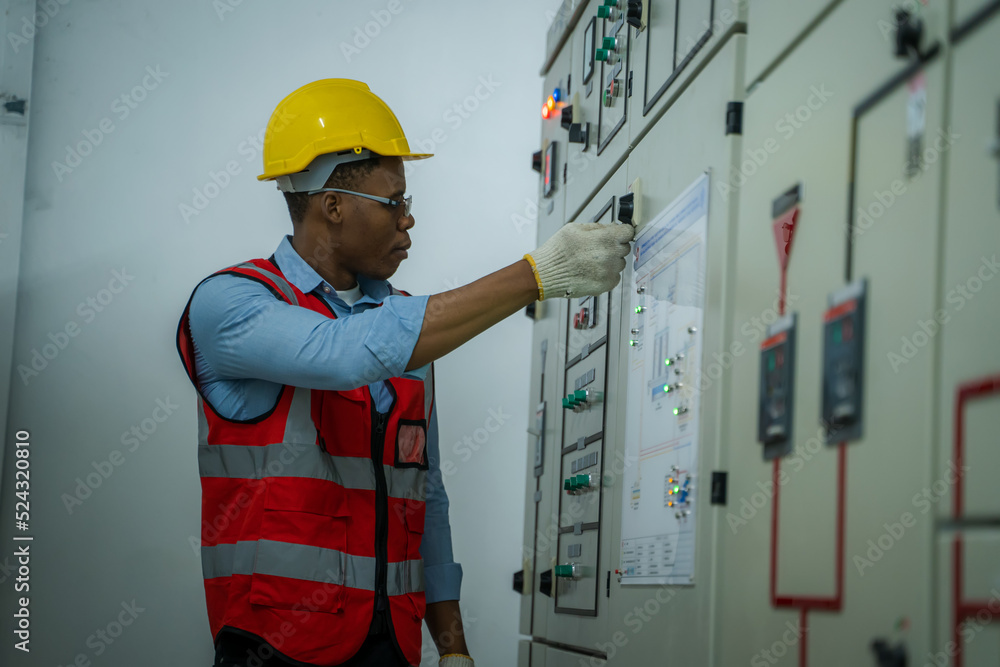 Engineer working in electrical control room,operator station network in