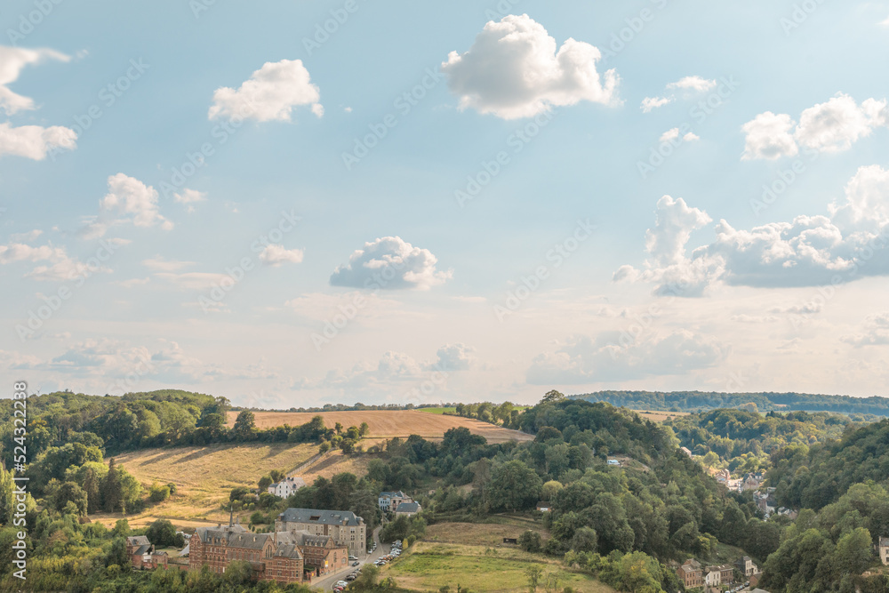 Gorgeous European countryside landscape in summer. Panoramic view of the sky, fields and buildings
