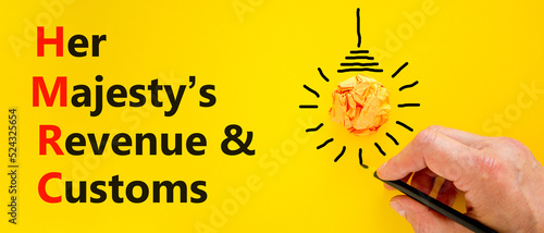 HMRC her majestys revenue and customs symbol. Concept words HMRC her majestys revenue and customs on beautiful yellow background. Business HMRC revenue and customs concept. Copy space. photo