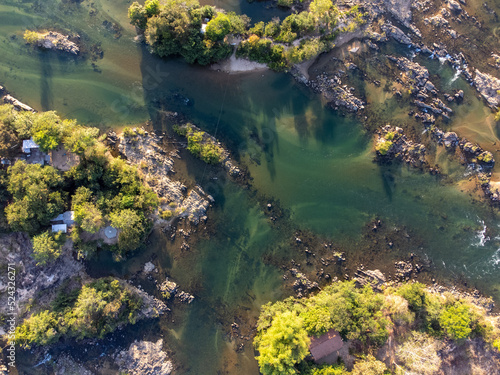 river bird top view with rocks  sand and forest