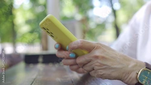 Wallpaper Mural Closeup of mature woman hands uses cellphone. Soft focus, slow motion Torontodigital.ca