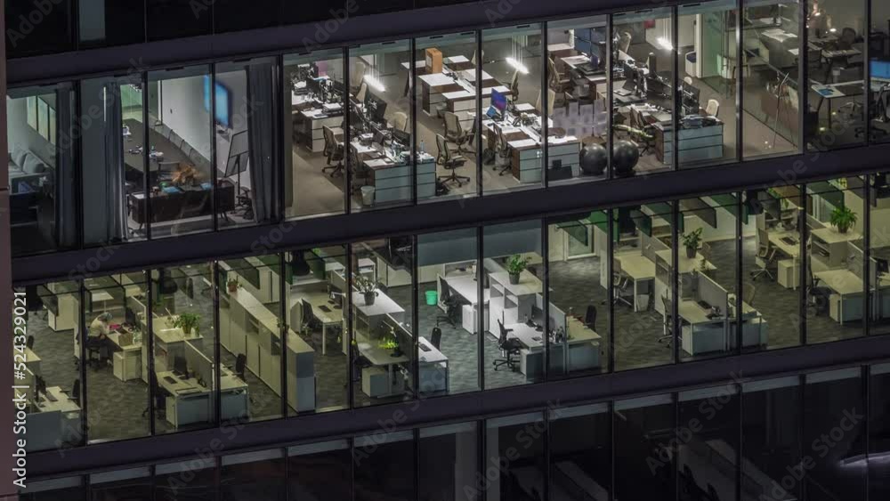 Big glowing windows in modern office buildings timelapse at night, in rows of windows light shines. Open space working places Big glowing windows in modern office buildings timelapse at night, in rows of windows light shines. Open space working places
