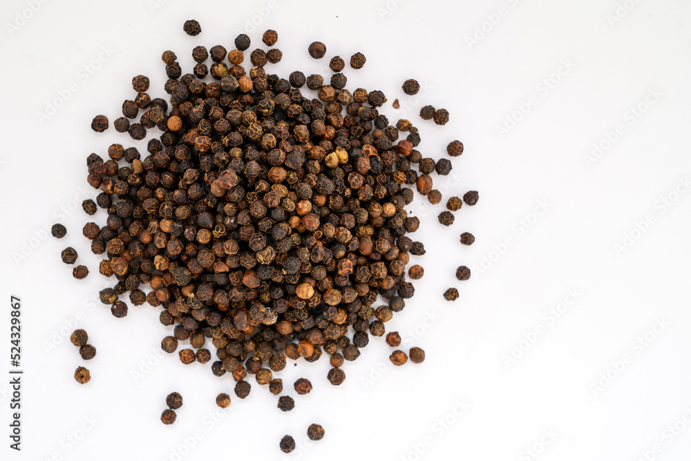 spices black pepper whole peas close-up on a white background spices black pepper whole peas close-up on a white background