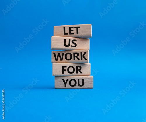 Let us work for you symbol. Wooden blocks with words Let us work for you. Beautiful blue background. Business and Let us work for you concept. Copy space.