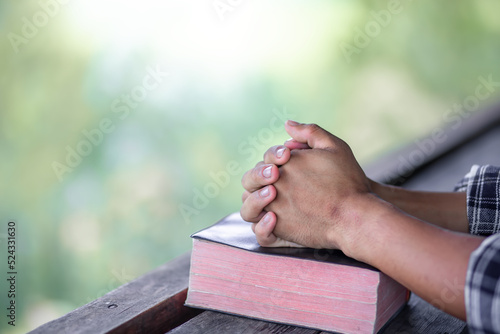 Close up hands praying on Bible. space for your individual text.
