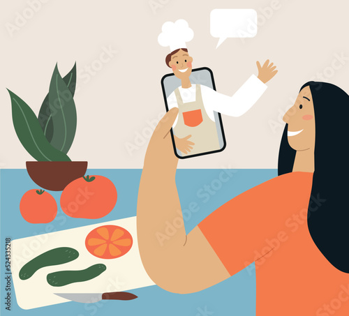 Woman cooks at home with cook’s video, tutorial, recipe video with ingredients on the countertop. Online cooking in a mobile device. Education, culinary, homemade food concept flat vector illustration