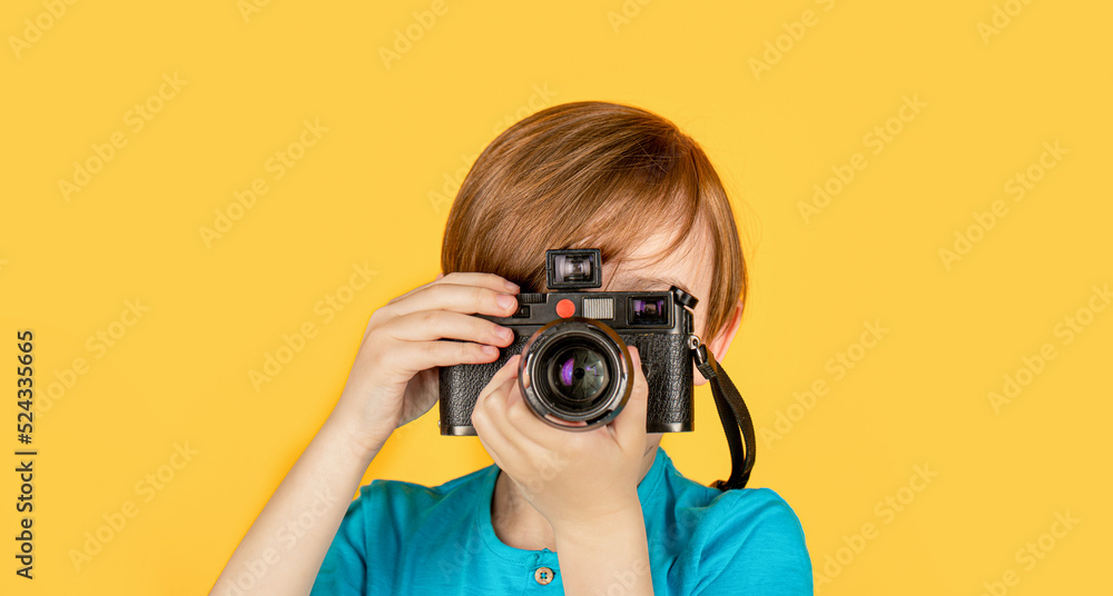 Boy using a cameras. Baby boy with camera. Cheerful smiling child