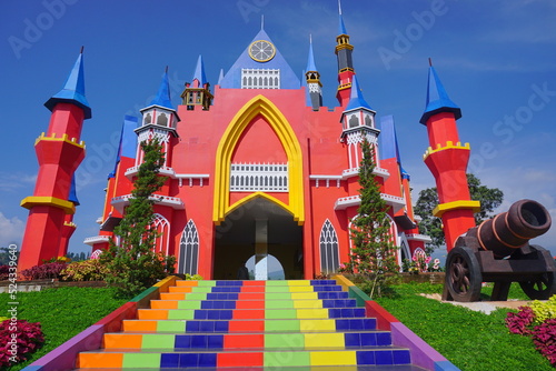 Colorful castle with stairs and flowers garden under blue skies. Florawisata dcastello Subang. One of the most popular travel destinations abd spot tourism of west java Indonesia.  photo