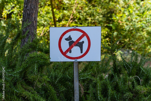 a rectangular sign prohibiting the walking of dogs and other animals on the lawn of a public park, Signs with information.