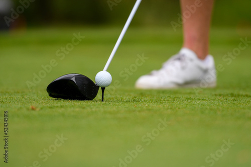 Golf Club Driver and Golf Ball on a Tee at Golf Course