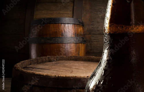 Beer. Still life with Vintage beer barrel and glass light beer. Fresh amber beer concept. Green hop and gold barley on wooden table. Ingredients for brewery. Brewing traditions