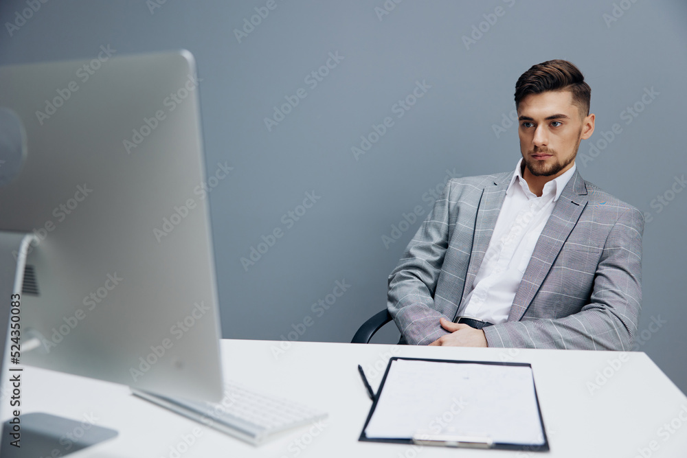 manager documents on the table computer work emotions Gray background manager documents on the table computer work emotions Gray background