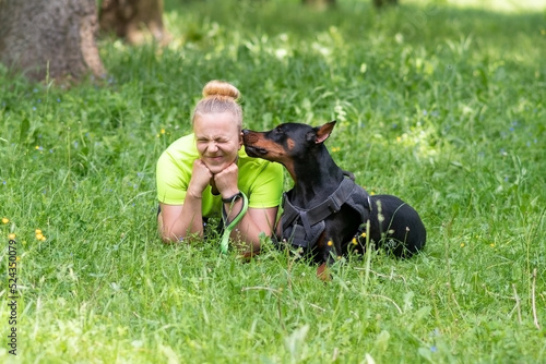Girl with a doberman show love to each other.