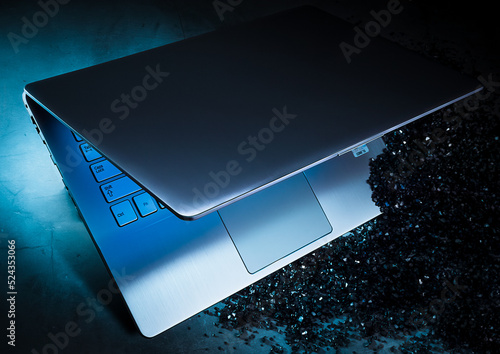 Metallic laptop in blue light, advertising look