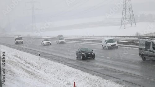 travel germany and bavaria, snow covered street at daytime with traffic in slow motion