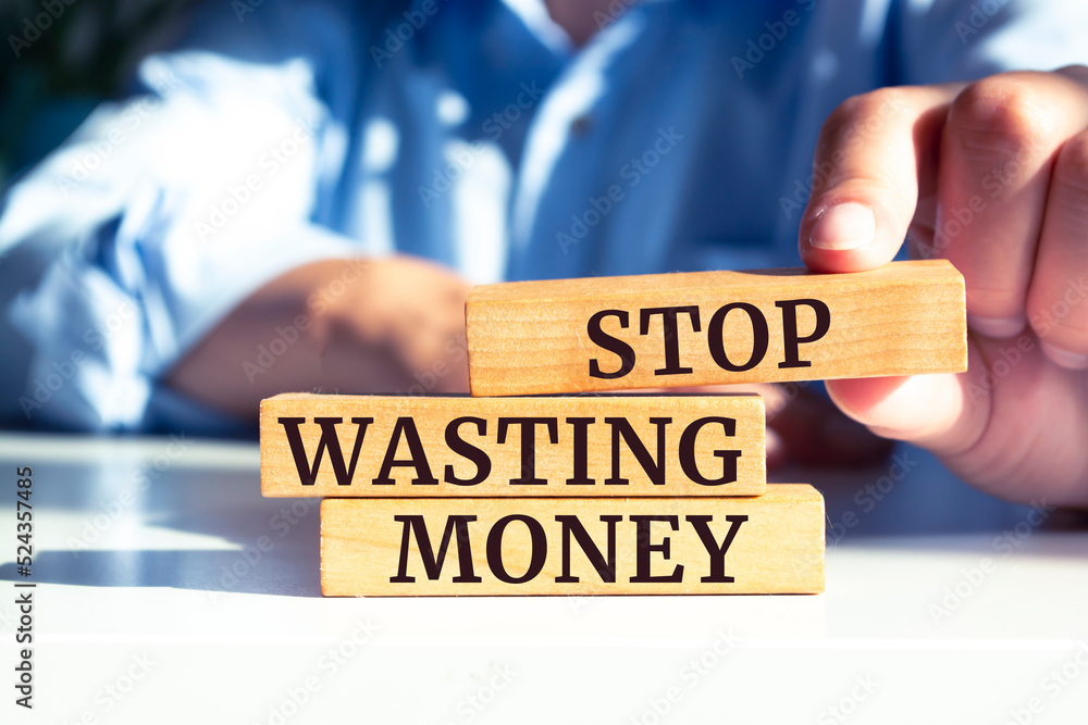 Wooden blocks with words 'Stop wasting money'. Wooden blocks with words 'Stop wasting money'.