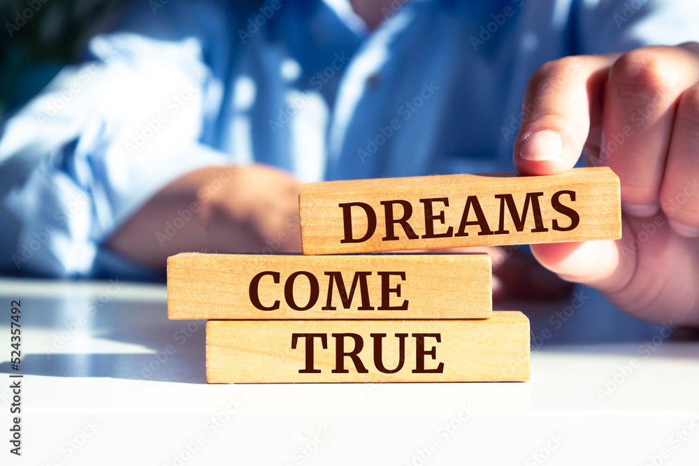 Wooden blocks with words 'Dreams come true'. Wooden blocks with words 'Dreams come true'.