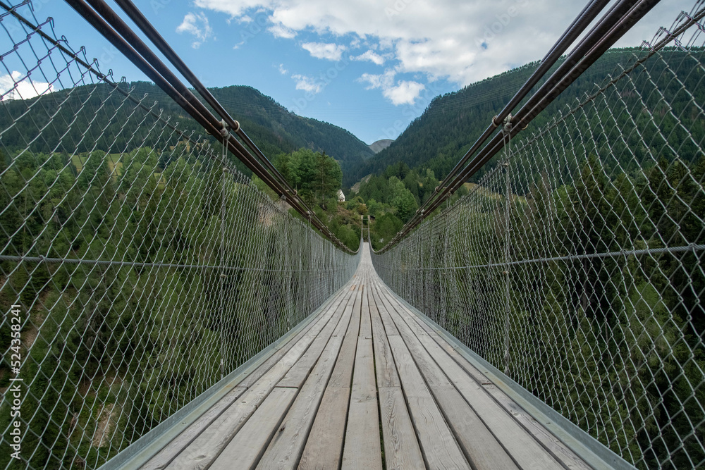 Obraz premium Suspension bridge in Muhlebach, over the Rhone river